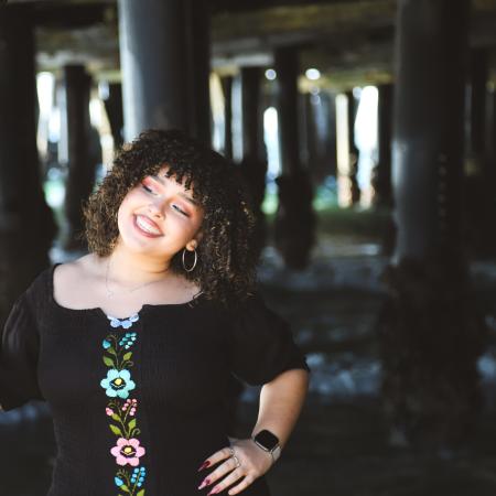 AJ posing at beach under the pier